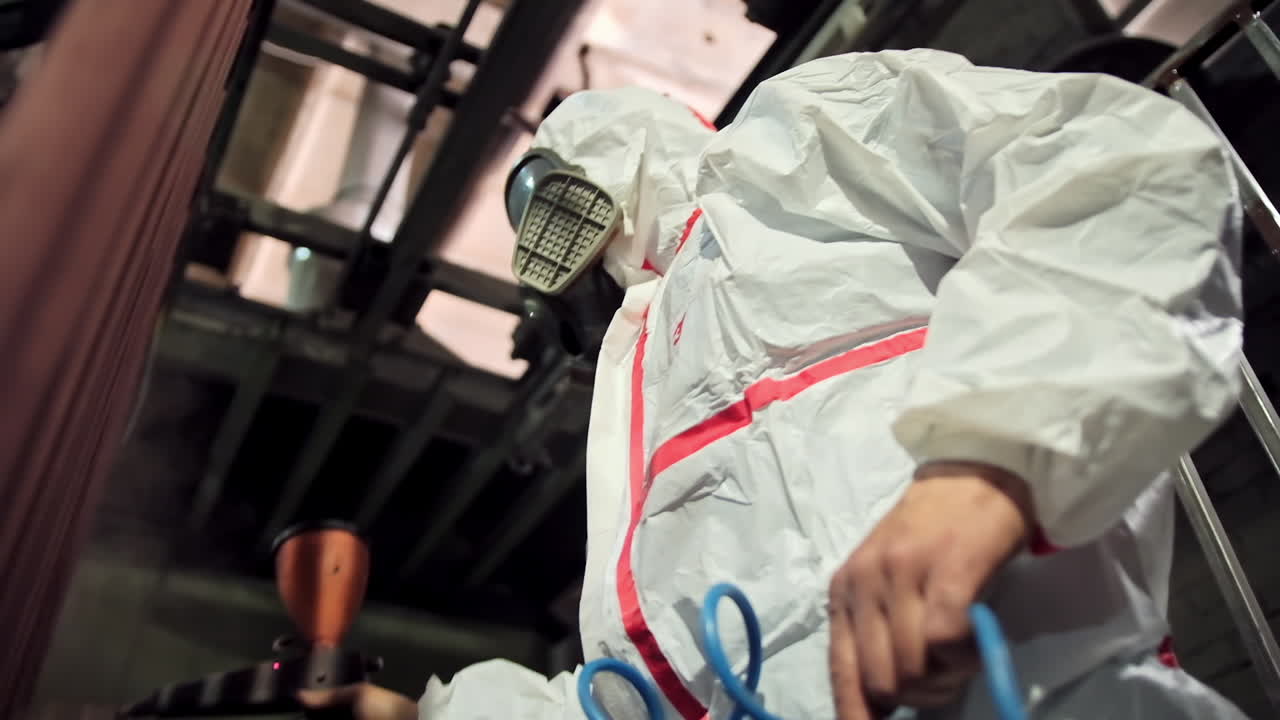 Worker painting sheet metal. Painter working painting the steel structure