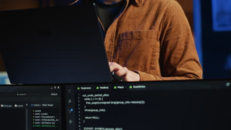 cheerful programmer writing lines of code on notebook in living room