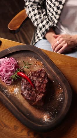 woman enjoying a delicious steak dinner