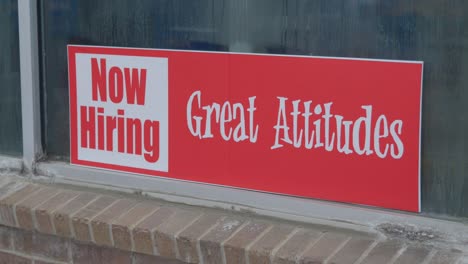 now hiring great attitudes bright red and white sign in window of car wash with condensation and dew on glass, semi-close up static camera angle in cinema 4k 30fps slowed from 60fps