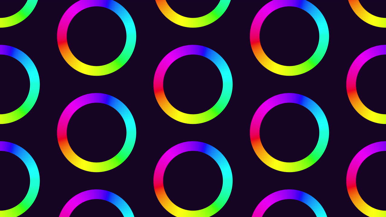 Vibrant rainbow circles on a black backdrop form an eye-catching circular pattern in this image. The bright colors overlap, creating a striking visual contrast