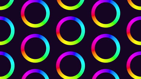 vibrant rainbow circles on a black backdrop form an eye-catching circular pattern in this image. the bright colors overlap, creating a striking visual contrast