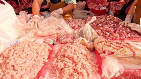 hands packing and weighing ground meat at market