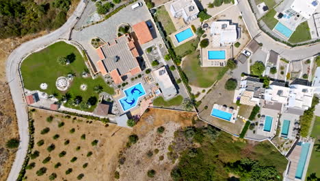 top down drone shot rotating above a holiday resort, sunny day in greece