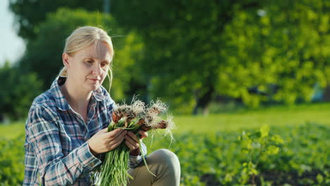 Mujer-Sosteniendo-Cebollas-Verdes-Frescas-Recién-Arrancadas-Del-Jardín