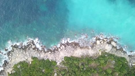 birdseye view of waves crashing against the coastline in the adriatic sea