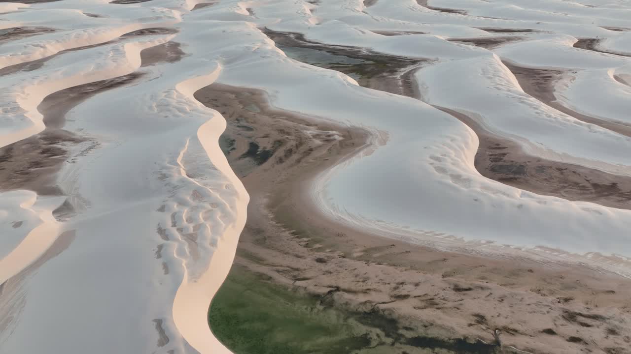 Aerial shot of Lençóis Maranhenses with vast sand dunes and stunning water lagoons.