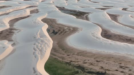 aerial shot of lençóis maranhenses with vast sand dunes and stunning water lagoons.