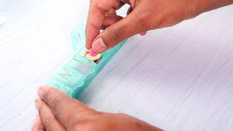 persona que utiliza un organizador de pastillas