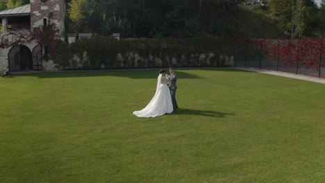 lovely newlyweds caucasian bride groom walking in park, holding hands, wedding couple family
