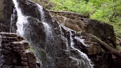 stone waterfall in mountain forest. waterfall on rocky mountain