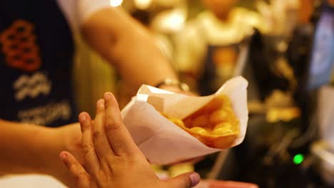 exchange of bubble waffles at a food stall