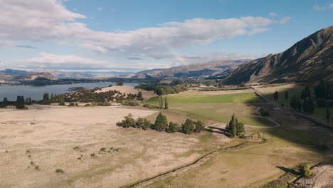 aerial view of scenic valley with lake and mountains