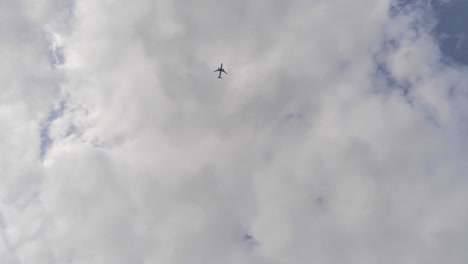 looking up to the sky as an airplane flies by