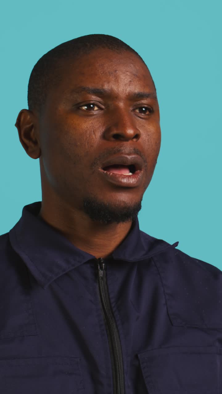 Close-up of a Black Man Yawning on a Blue Background