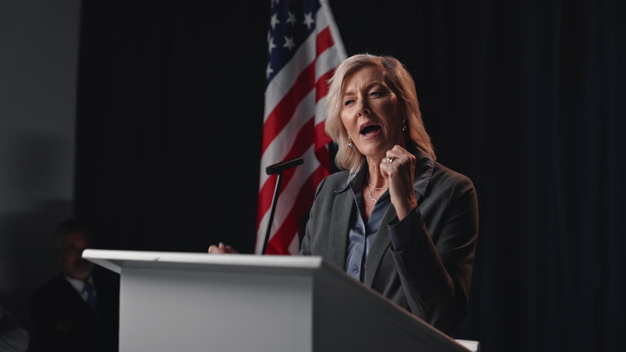 Woman Giving Speech at Podium with American Flag