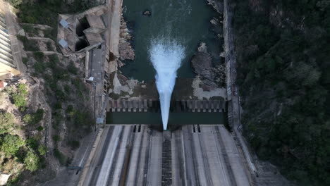 Massive-concrete-water-dam-for-electricity-production-in-Spain,-aerial-top-down-view