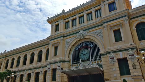 visitors admiring the french-designed saigon central post office, a building constructed in the 19th century, as it now stands in modern ho chi minh city.