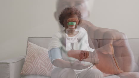 animation of male doctor holding covid 19 vaccine over senior woman measuring blood pressure