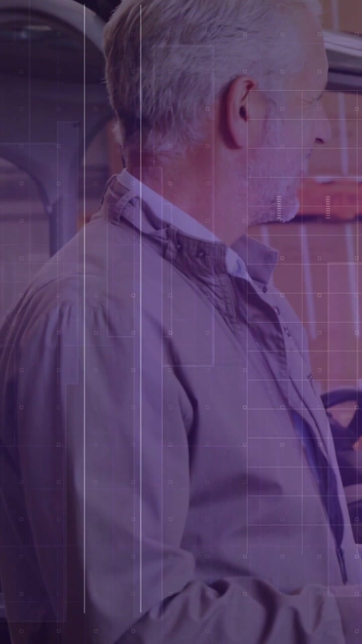 Auto tech hearing off-frame voice, turning head and smiling while static grid overlay staying