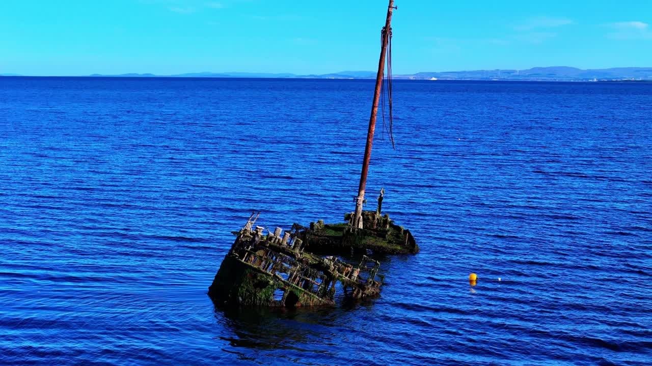 Aerial orbital view, Shipwrecked remains of Puffer vessel above the surface of the firth of Clyde at Ayr Scotland