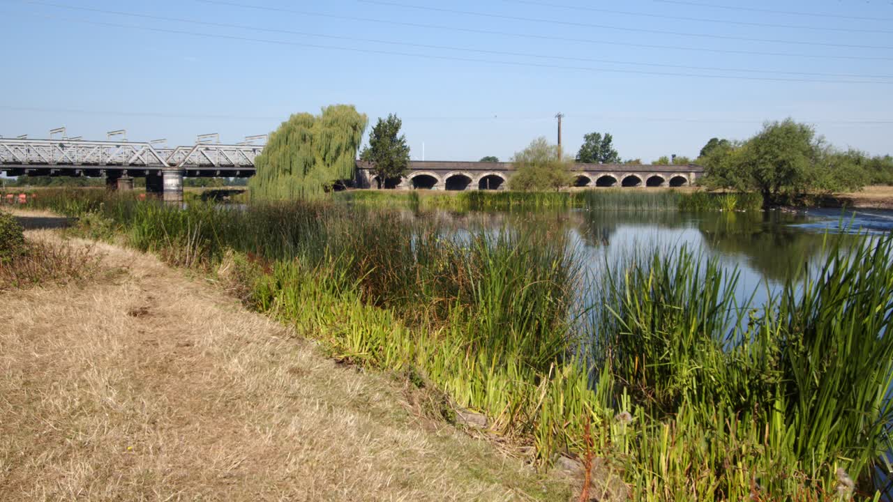 River Trent with the Trent Railway line bridge in background, by Ratcliffe on Soar Power station. Wide shot