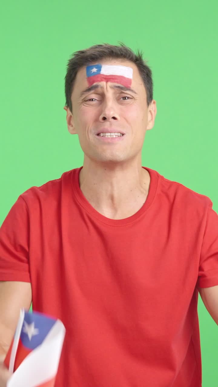 Man cheering for Chile during a match that is lost