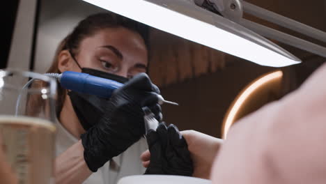 woman getting her nails done at a salon