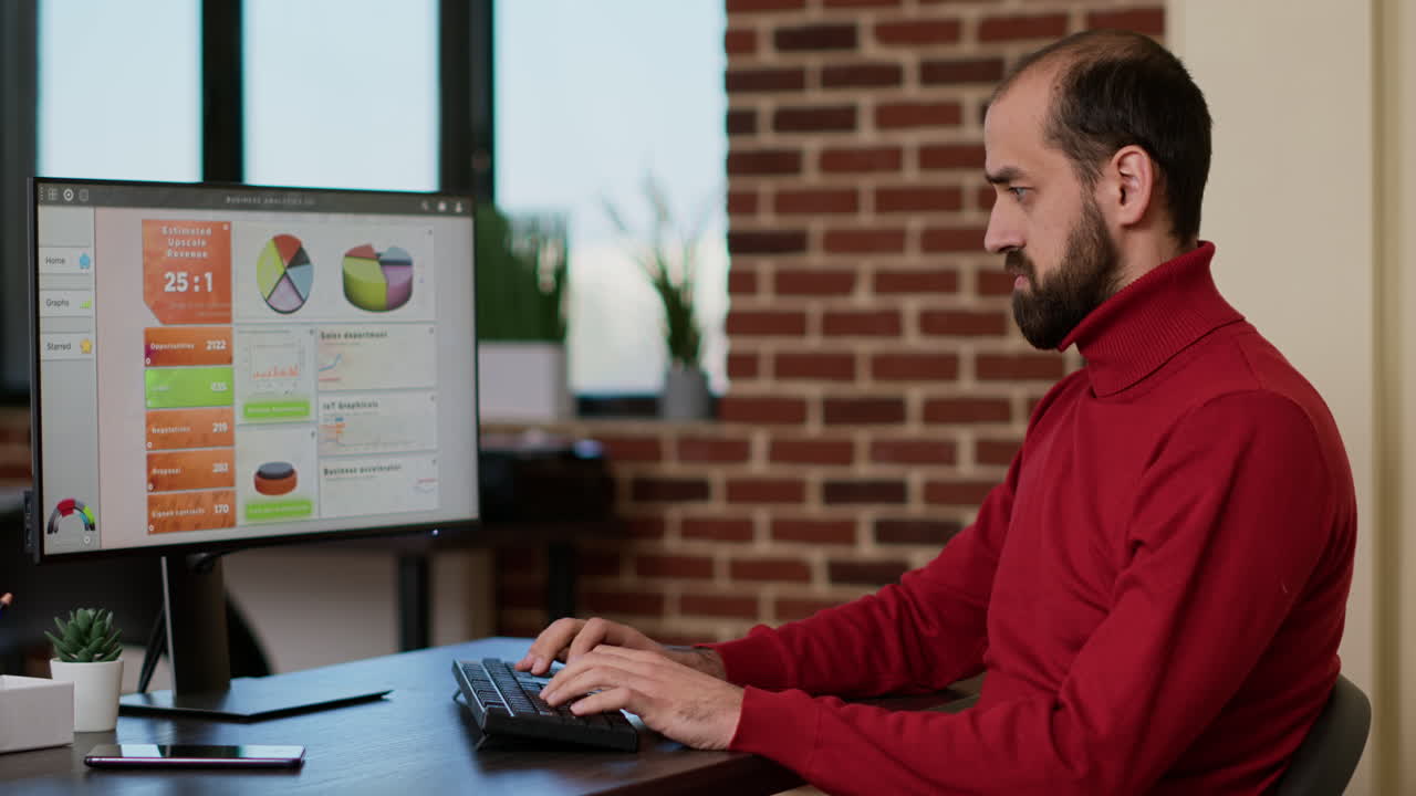 Male employee working on computer to develop sales profit