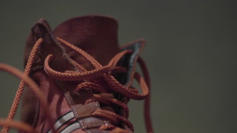 close-up of a brown shoe with orange laces