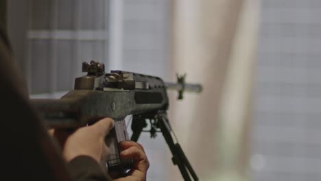 shooter loading a magazine in ruger mini-14 rifle in slow motion