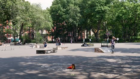 slow motion landscape of tompkins square skatepark ramps ledges on basketball court suburbs of new york city manhattan brooklyn usa america sports fitness lifestyle