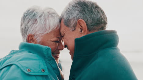 happy, hug and senior couple at a beach