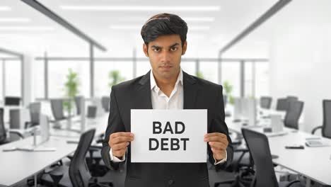 angry indian manager holding bad debt banner