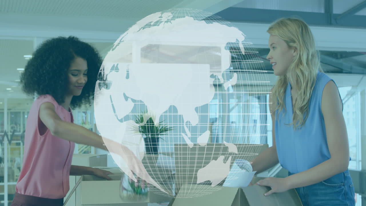 Two women unpacking documents in modern office, showcasing global business data with floating globe