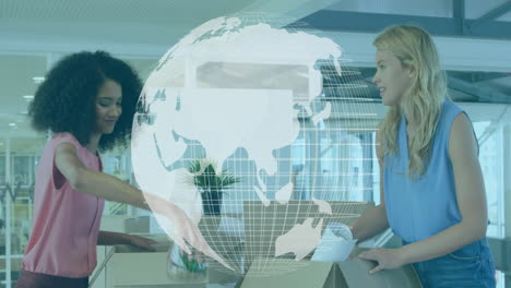 two women unpacking documents in modern office, showcasing global business data with floating globe
