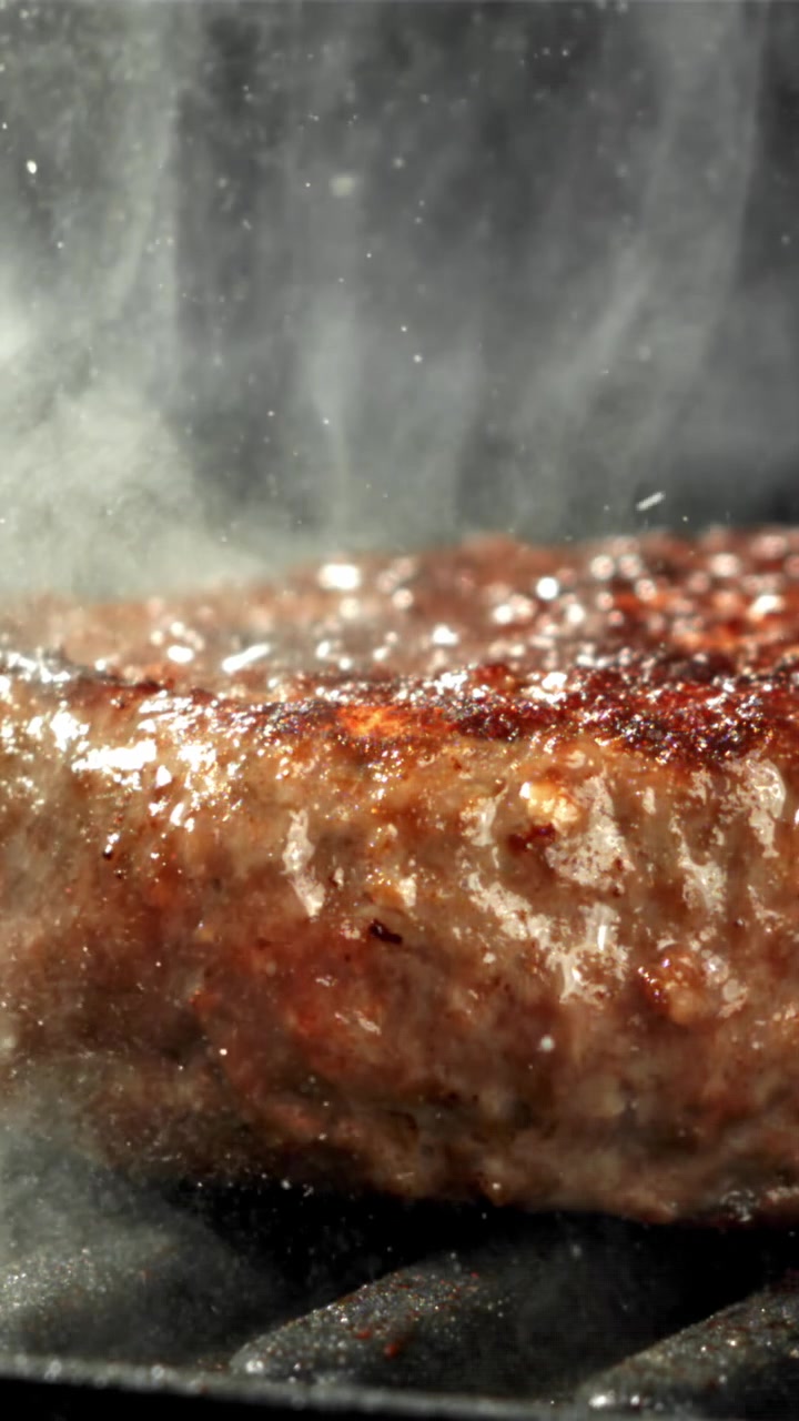Close-up of a Hamburger Patty Sizzling on a Hot Grill