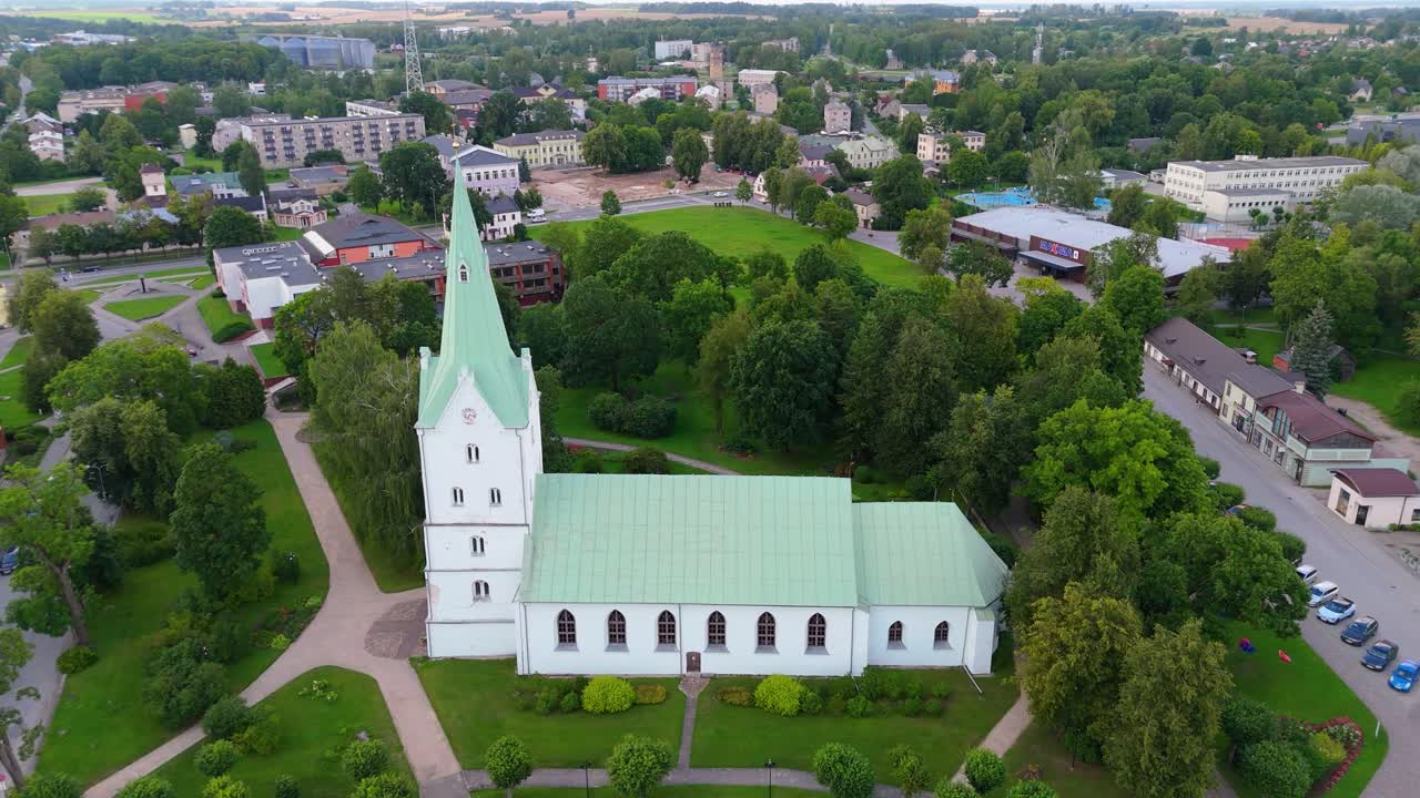 Aerial Panorama of Dobele Town Center and Evangelical Lutheran Church at Summer Scenic Drone View in Golden Hour Light Over Dobeles Historic Center on a Warm Summer Evening Peaceful Latvian Town