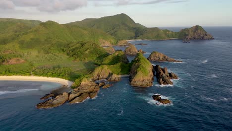 aerial panorama of the green tropical island with cliffs and rocky shore