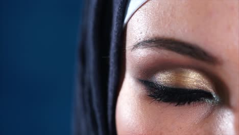 close-up of a woman wearing a hijab with intricate eye makeup