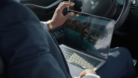 businessman working on laptop in a car