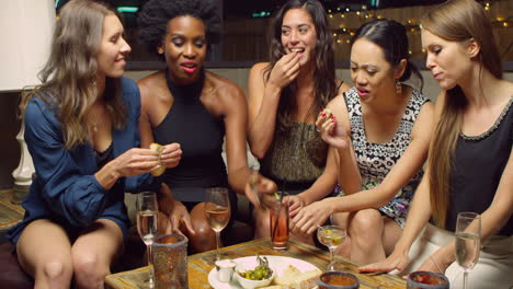 female friends enjoying night out at rooftop bar shot on r3d
