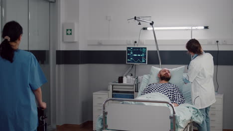 sick man resting in bed during respiratory recovery in hospital ward