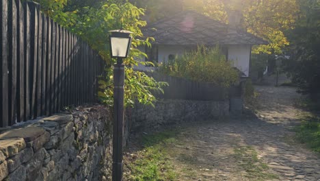 Golden-dappled-autumnal-sunlight-cobbled-lane-rustic-charm-village