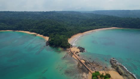 aerial view from bom bom beach and lowering the camera revealing the walkway that connects the beach at bom bom islet at ilha do principe, são tomé,africa