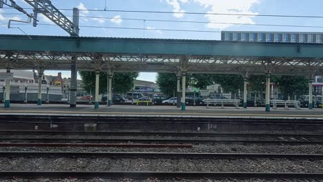 people and trains at cardiff station platform