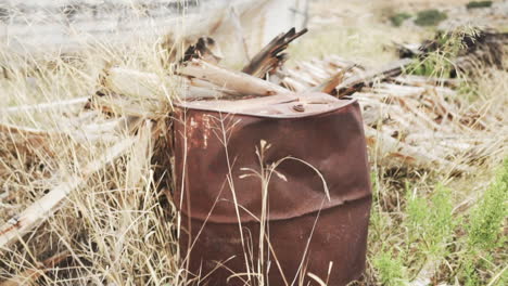 Dolly-in-shot-of-an-abandoned-dusty-barrel-in-the-middle-of-the-nature,-grunge-and-industrial-concept