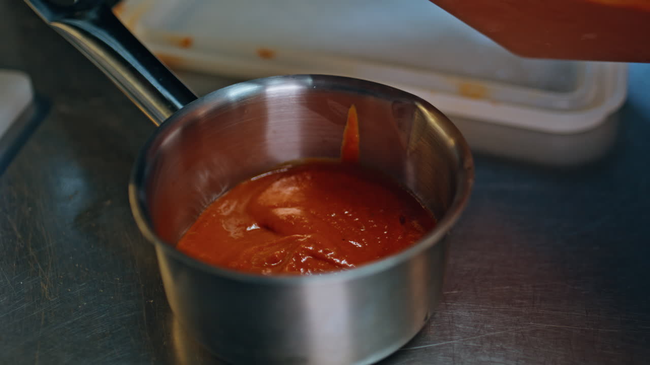 Man hands making sauce in modern cafeteria cuisine closeup. Unknown male chef