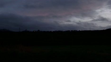 timelapse of village on a hill as night falls