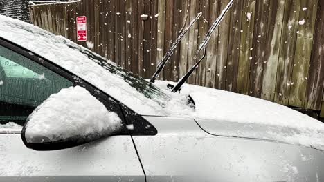 Thick-Snow-Falling-In-Parked-Vehicle-In-Winter---aerial-shot